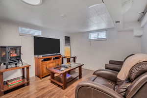 Living area featuring a wood stove and light wood-type flooring