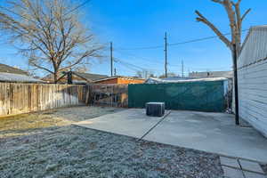 Fenced backyard with a patio