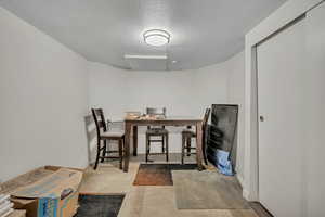 Dining area featuring a textured ceiling and baseboards