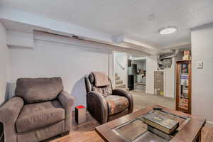 Living room featuring light wood-style flooring and stairs