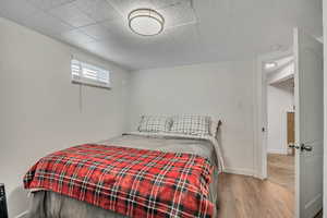 Bedroom featuring wood finished floors and baseboards