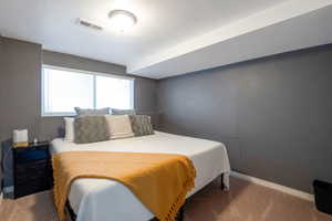 Bedroom featuring carpet flooring and a textured ceiling
