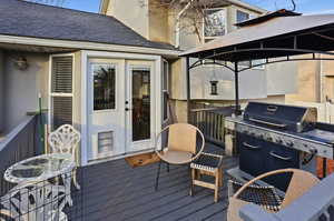 Wooden terrace with a gazebo and grilling area