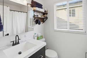 Bathroom featuring vanity and curtained shower