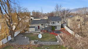 Rear view of house featuring a patio, a fenced backyard, stucco siding, and a shingled roof