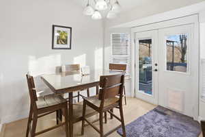 Dining area with a chandelier and light wood finished floors