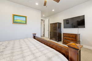 Carpeted bedroom featuring recessed lighting and ceiling fan