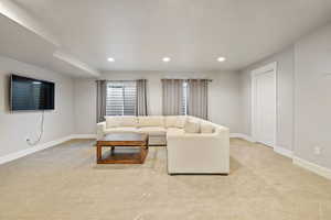 Living room with light carpet and recessed lighting