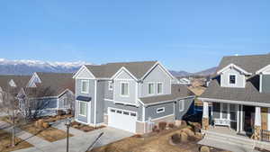 View of front of property with roof with shingles, a residential view, and driveway