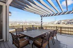 Wooden terrace with outdoor dining space and a residential view