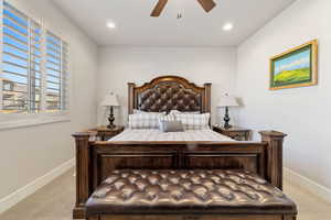 Carpeted bedroom with ceiling fan and recessed lighting