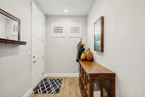 Doorway featuring wood finished floors and recessed lighting