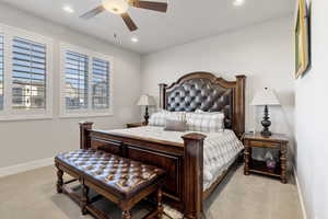 Bedroom with light colored carpet, ceiling fan, and recessed lighting