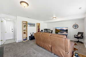 Living room featuring carpet flooring and baseboards