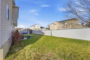 Fenced backyard with a shed and a residential view