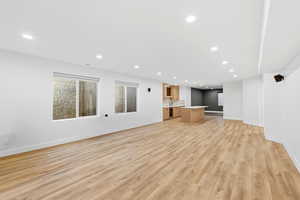 Unfurnished living room with light wood finished floors and recessed lighting