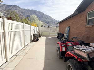 View of patio with a mountain view and a gate