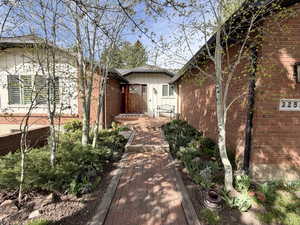 View of property exterior with board and batten siding and brick siding
