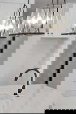 Detailed view of a chandelier and light stone countertops