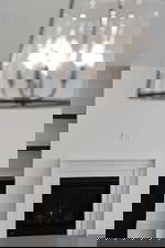 Detailed view of a fireplace and a textured ceiling