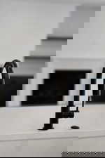 Kitchen view of a sink and light countertops