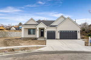 Modern farmhouse style home featuring a garage, concrete driveway, brick siding, and a standing seam roof