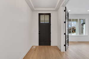Entryway featuring light wood-style flooring, recessed lighting, and a textured ceiling