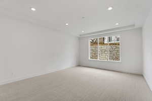 Carpeted empty room with baseboards and recessed lighting