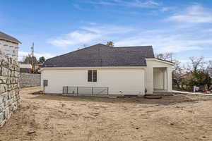 View of side of home featuring a shingled roof