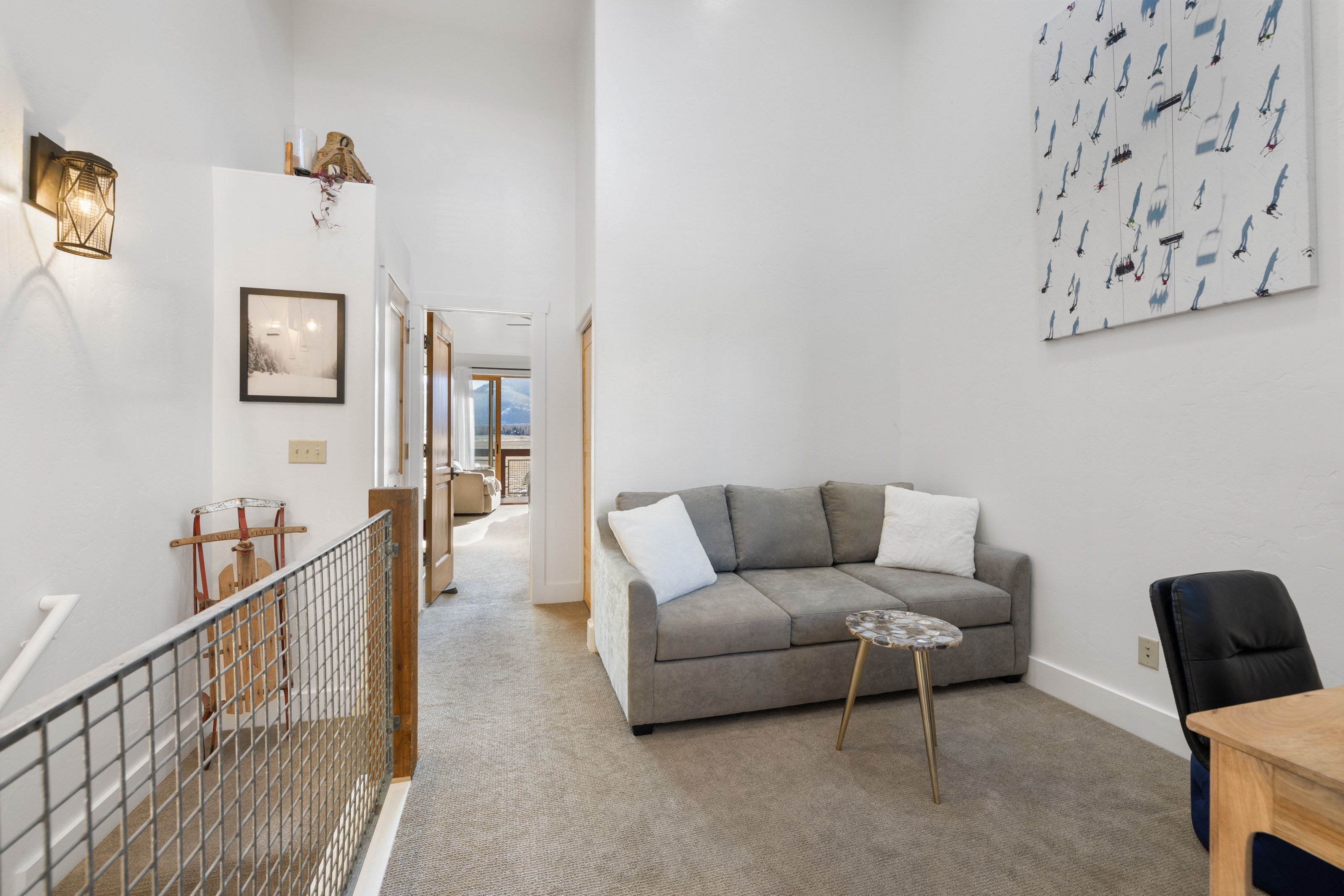 Carpeted living area with a towering ceiling and baseboards