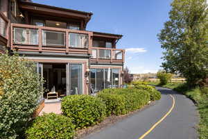 Back of property featuring a balcony and a sunroom