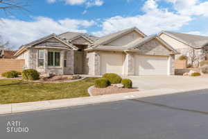 Single story home with concrete driveway, a garage, and brick siding