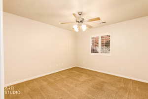 Empty room featuring carpet and ceiling fan