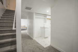 Stairs featuring marble finish floors, carpet floors, and recessed lighting