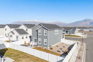 Back of property with a residential view, a fenced backyard, a mountain view, and stucco siding