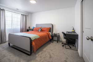 Bedroom featuring light colored carpet and baseboards
