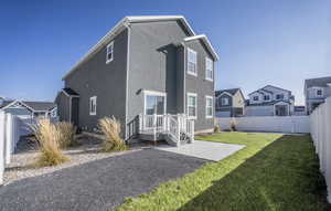 Back of house with a fenced backyard, stucco siding, a patio area, and a residential view