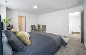 Carpeted bedroom featuring baseboards