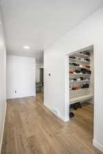 Corridor with light wood-type flooring