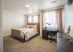 Carpeted bedroom featuring baseboards