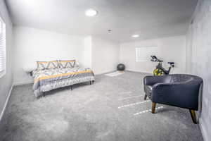 Bedroom featuring carpet floors and baseboards