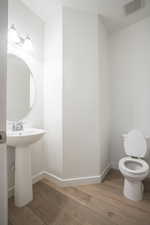 Half bathroom with light wood-style floors