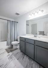 Bathroom featuring shower / bath combo and vanity