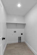 Washroom featuring baseboards and hookup for a washing machine