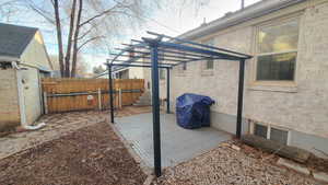 View of patio featuring grilling area and a pergola