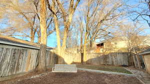 View of fenced backyard with Tree Swing