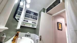 Bathroom with a sink and a wainscoted wall