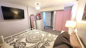 Bedroom featuring light colored carpet and a closet