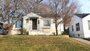 Bungalow-style house with a front lawn