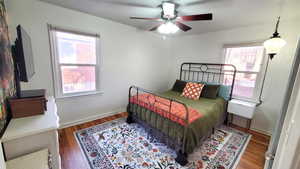 Bedroom featuring wood finished floors and ceiling fan